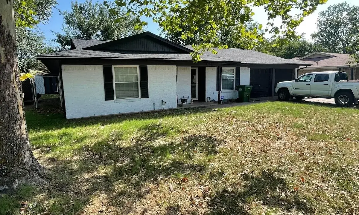Professional roofing crew working on a residential roof in Longwood